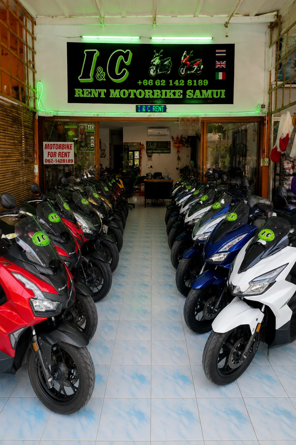 Real I&C rental scooters lined up inside the shop in Koh Samui