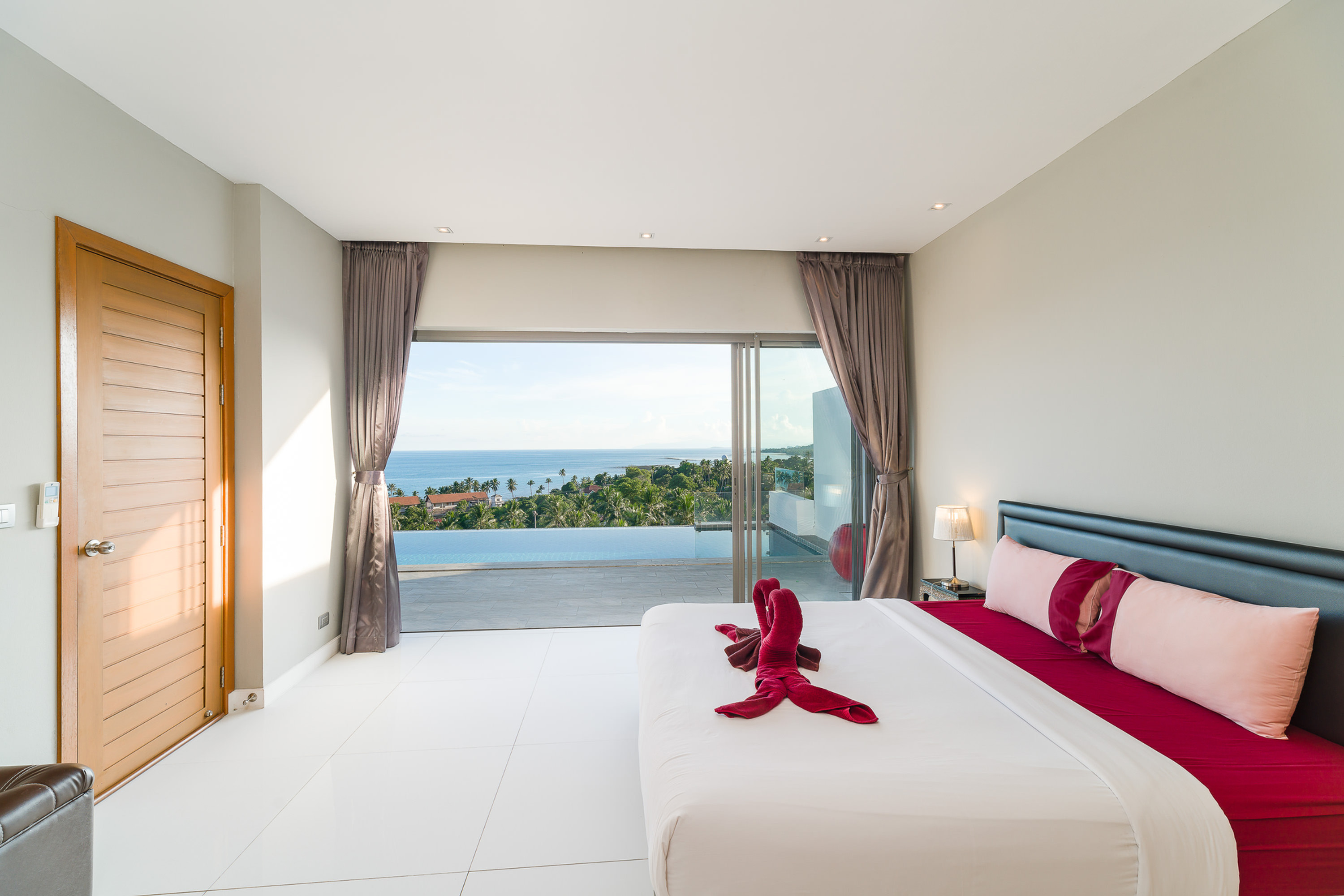 Bedroom opening onto a private pool and sea view at Tropical Sea View Residence